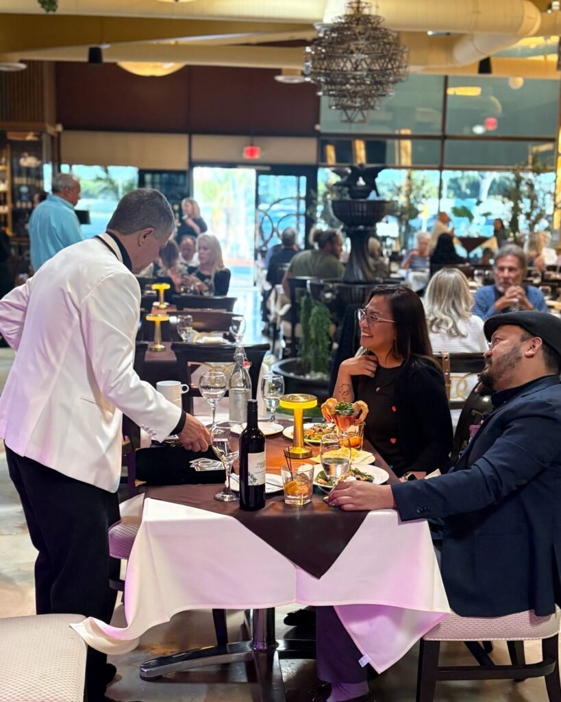 Brownbeauty Magic Instagram post: magician performing at a table in a full dining room
