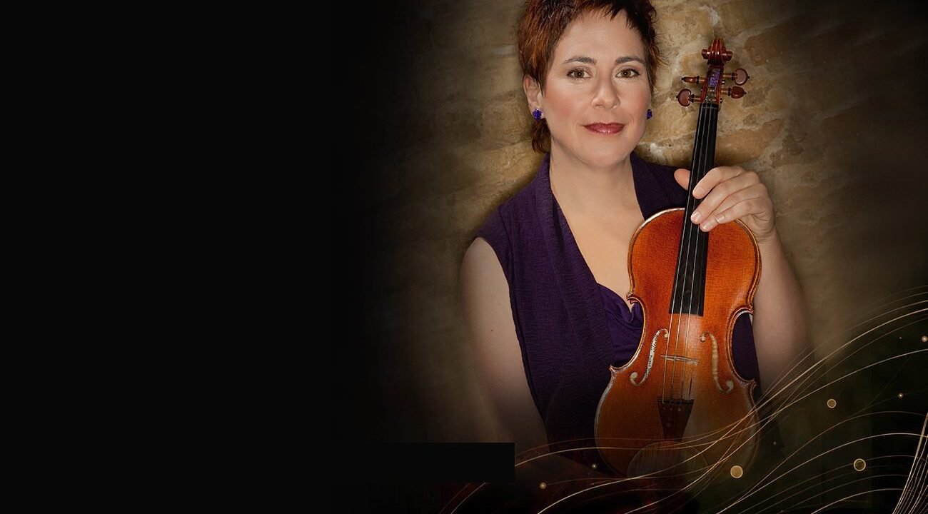 Concert violinist Dylana Jenson holding her violin, from the website we designed